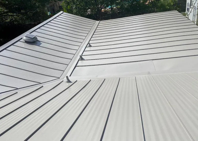 Solar attic fan installed on a metal roof for Roof Ventilation in Dunedin